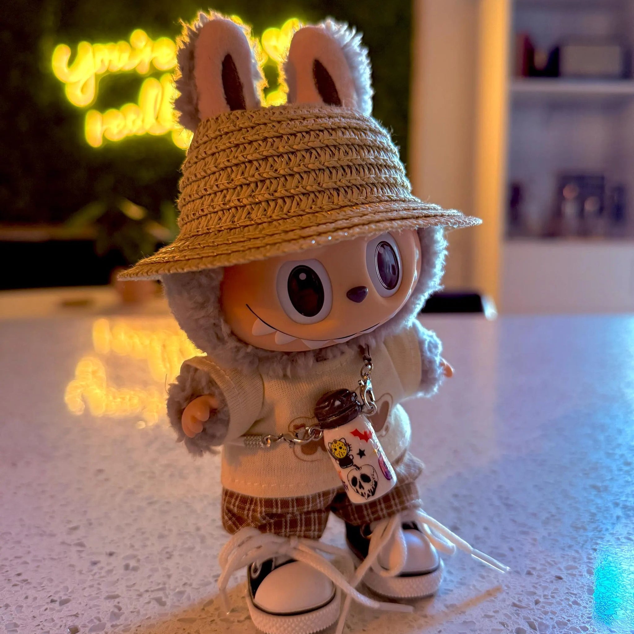 Toy figure with a straw hat on a surface with a blurred background